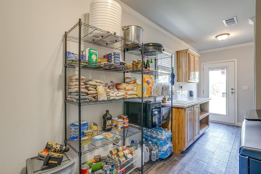 5878 Greenwood Road Millsap, TX 76066 - Photo 32 of 40 a kitchen with stainless steel appliances granite countertop a sink and cabinets