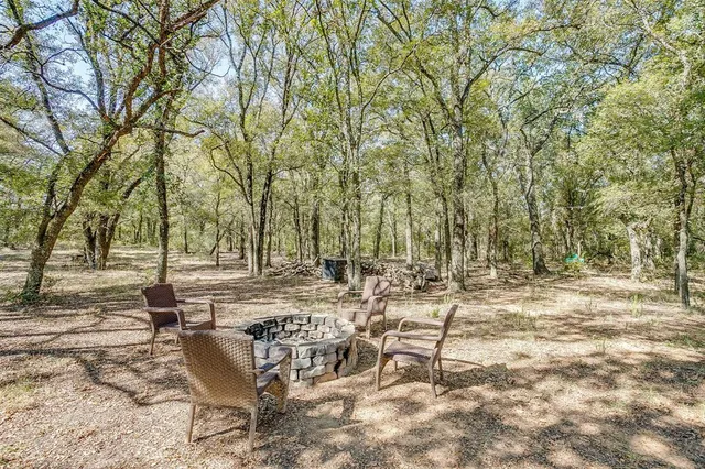 a view of backyard with a table and chairs