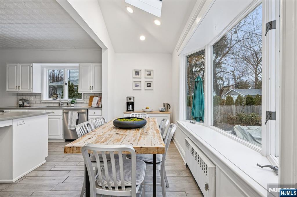 97 Montclair Avenue Montclair, NJ 07042 - Photo 13 of 42 a kitchen with a table chairs stove and cabinets