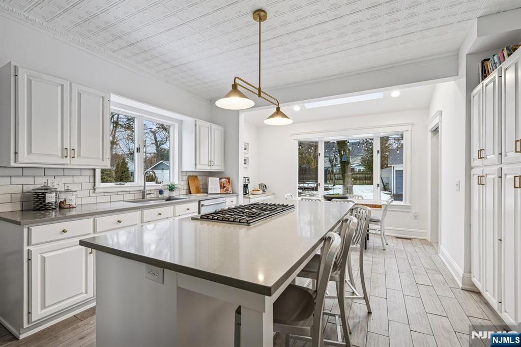 97 Montclair Avenue Montclair, NJ 07042 - Photo 15 of 42 a kitchen with a stove a sink a dining table and chairs