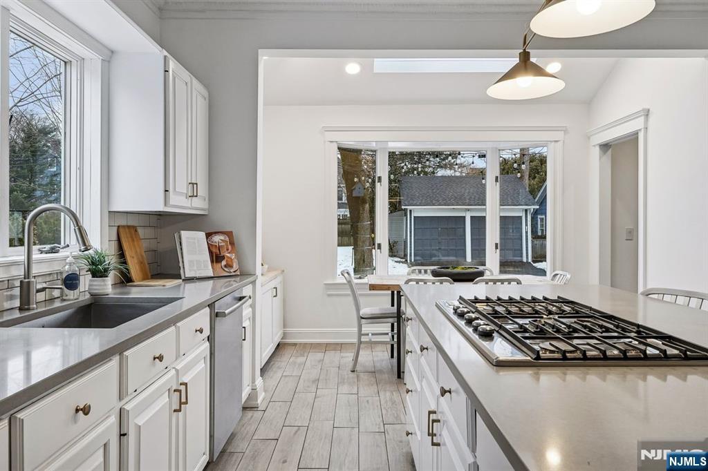 97 Montclair Avenue Montclair, NJ 07042 - Photo 16 of 42 a kitchen with a stove a sink and wooden cabinets