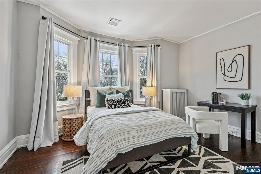 97 Montclair Avenue Montclair, NJ 07042 - Photo 21 of 42 a bedroom with a bed and a table in it with wooden floor