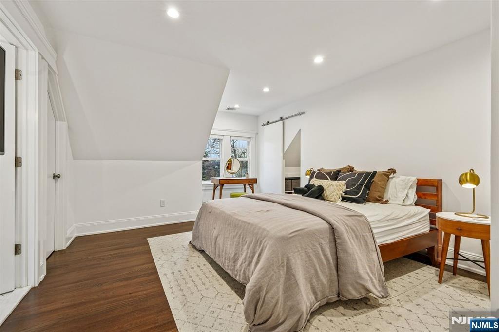 97 Montclair Avenue Montclair, NJ 07042 - Photo 24 of 42 a spacious bedroom with a bed and wooden floor