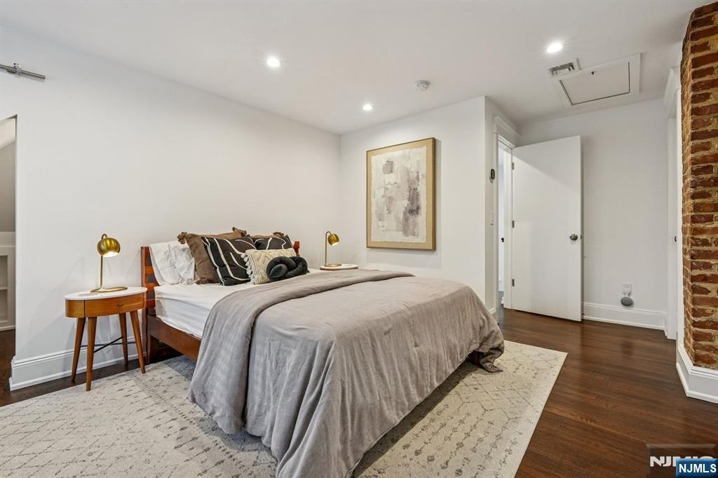 97 Montclair Avenue Montclair, NJ 07042 - Photo 25 of 42 a spacious bedroom with a bed and a table