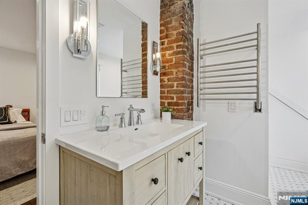 97 Montclair Avenue Montclair, NJ 07042 - Photo 29 of 42 a bathroom with a sink and a mirror