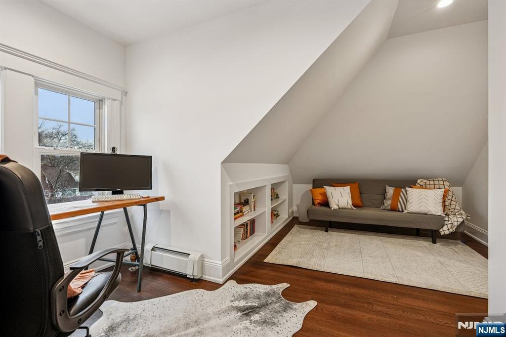 97 Montclair Avenue Montclair, NJ 07042 - Photo 32 of 42 a living room with furniture and a flat screen tv