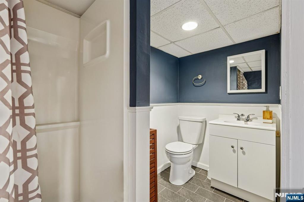 97 Montclair Avenue Montclair, NJ 07042 - Photo 33 of 42 a bathroom with a toilet a sink and mirror