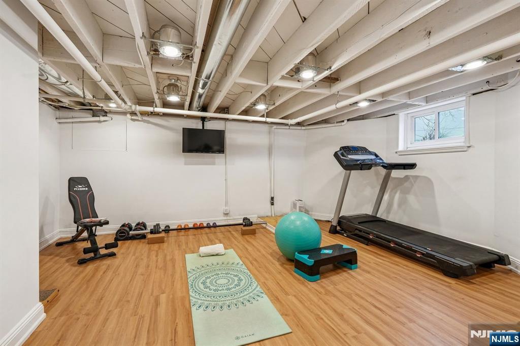 97 Montclair Avenue Montclair, NJ 07042 - Photo 35 of 42 a room with gym equipment and wooden floor