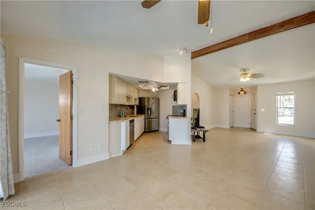a kitchen with a sink dishwasher a stove a refrigerator and cabinets