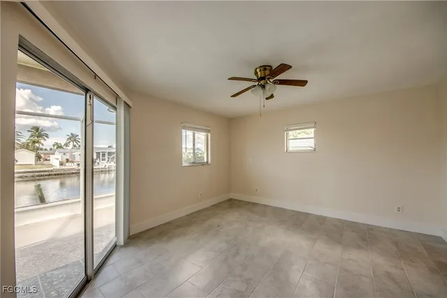 a view of empty room with ceiling fan