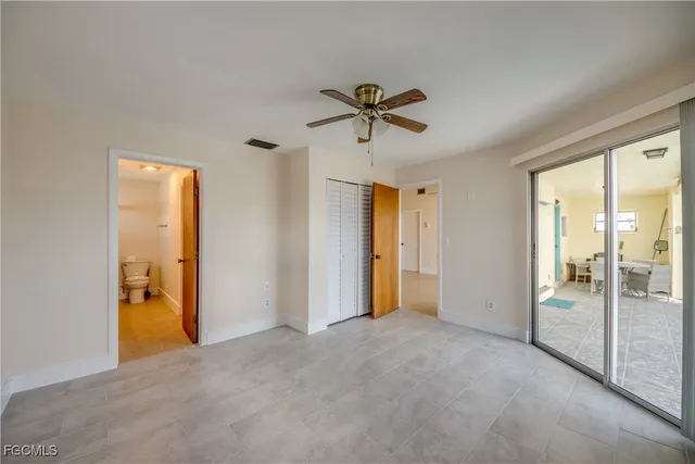 a bathroom with a granite countertop sink a toilet and a mirror