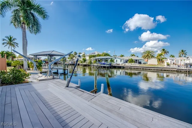 a view of a lake with chairs