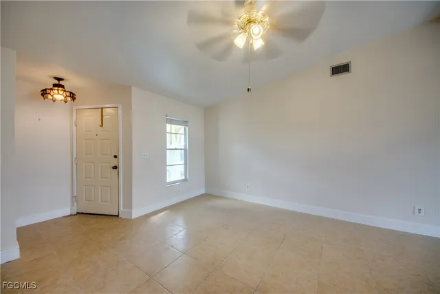 a view of a livingroom with a flat screen tv and a ceiling fan