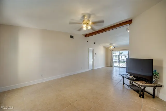 a view of a kitchen with furniture and a ceiling fan