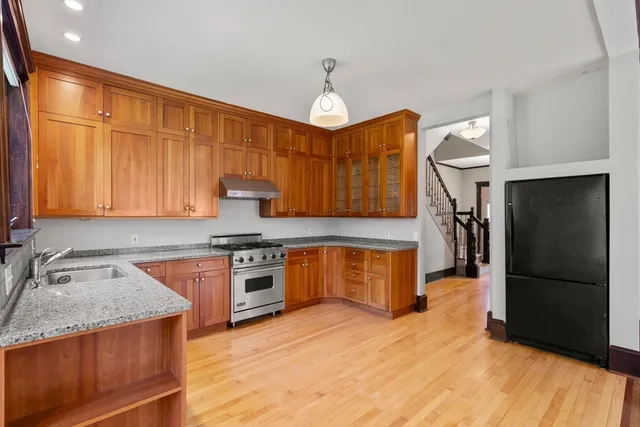 a kitchen with granite countertop stainless steel appliances and wooden cabinets