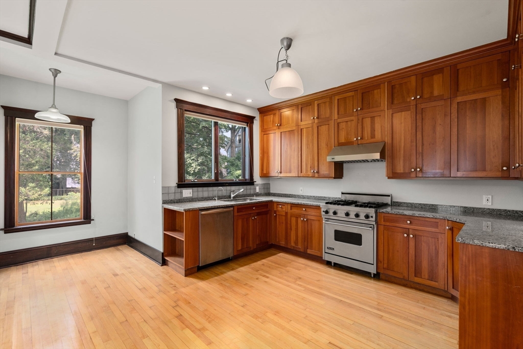 40 Cushing Street, Unit 40 Cambridge, MA 02138 - Photo 15 of 42 a kitchen with stainless steel appliances granite countertop a stove a sink dishwasher and a refrigerator