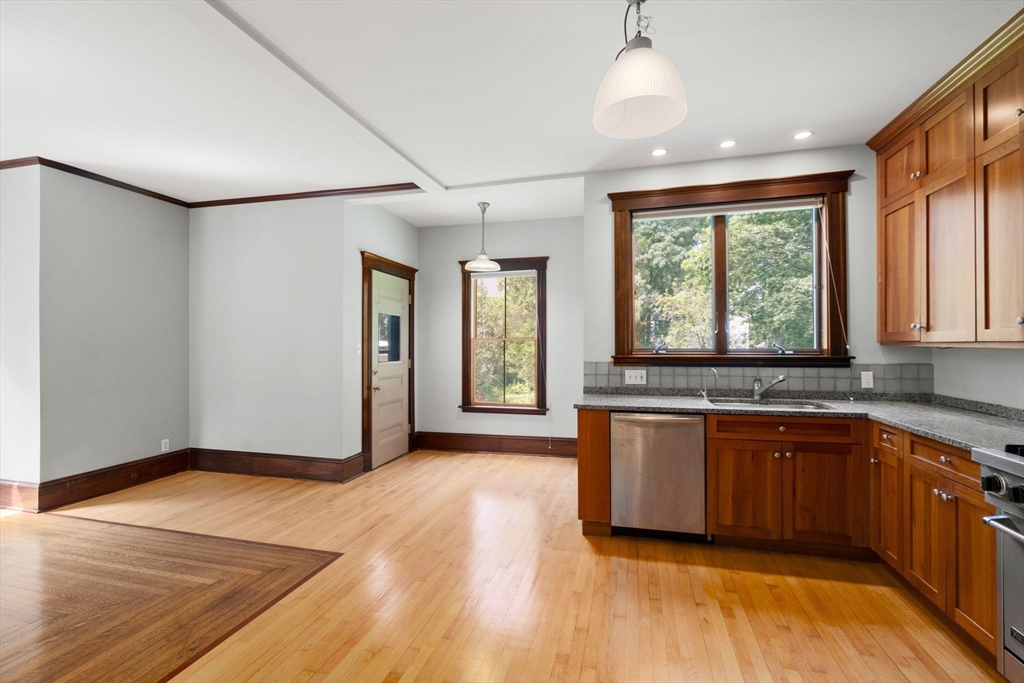40 Cushing Street, Unit 40 Cambridge, MA 02138 - Photo 17 of 42 a view of a kitchen with a sink and wooden floor