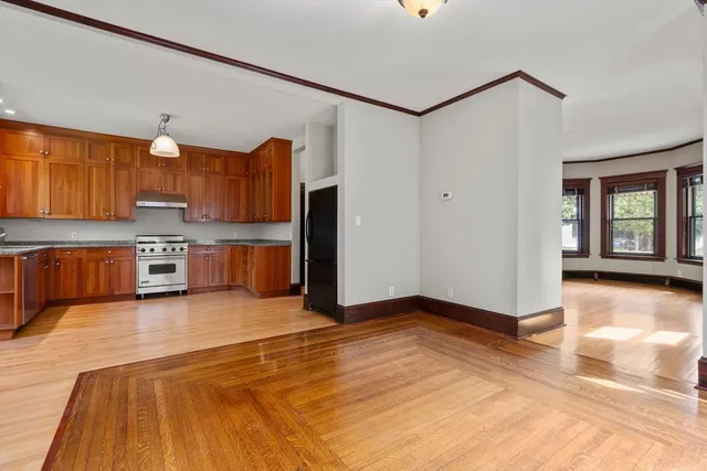 a view of kitchen with stainless steel appliances granite countertop a refrigerator and a stove top oven