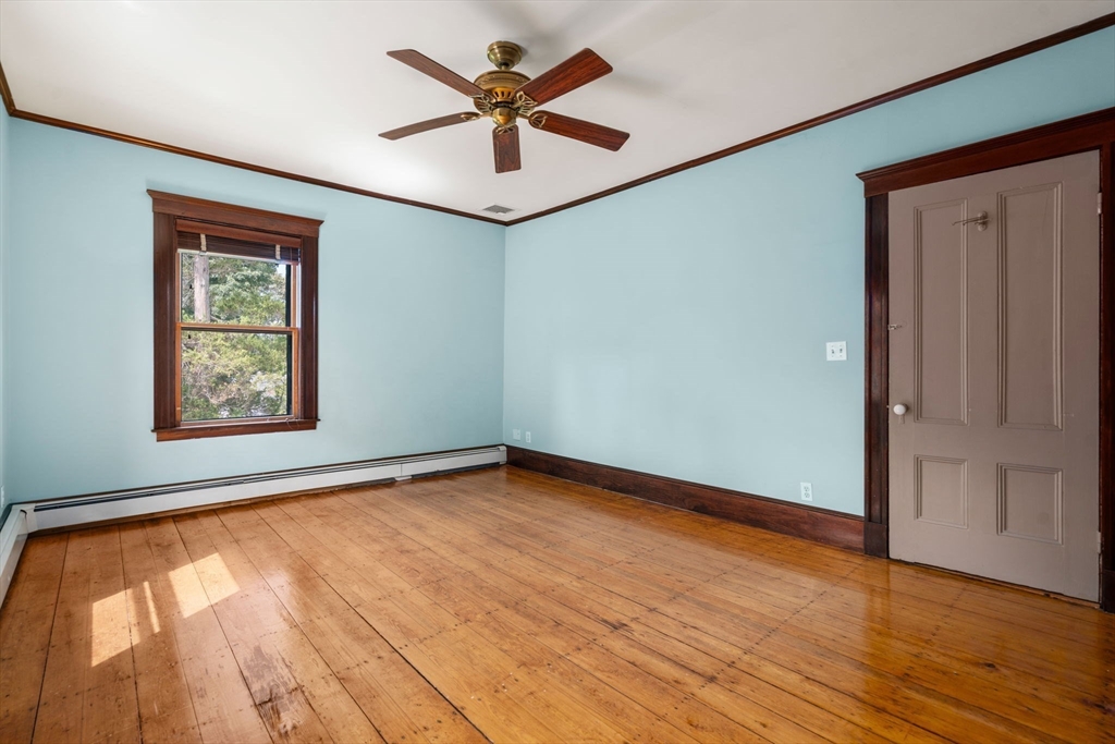 40 Cushing Street, Unit 40 Cambridge, MA 02138 - Photo 21 of 42 an empty room with wooden floor and windows