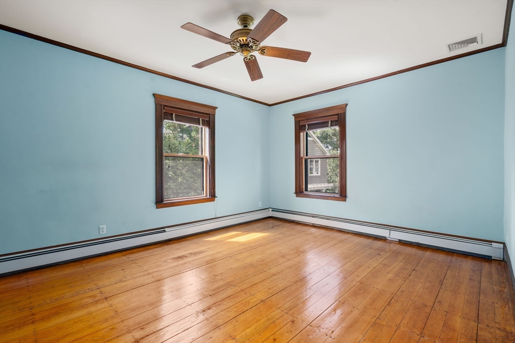 40 Cushing Street, Unit 40 Cambridge, MA 02138 - Photo 23 of 42 a view of an empty room with window and wooden floor