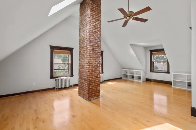 a view of a livingroom with wooden floor and stairs