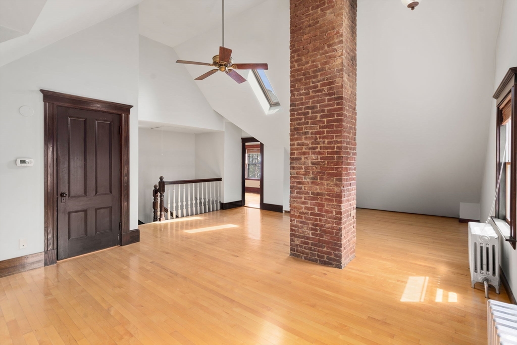 40 Cushing Street, Unit 40 Cambridge, MA 02138 - Photo 29 of 42 a view of a livingroom with wooden floor and stairs