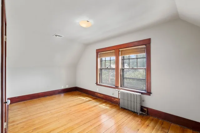 a view of a room with wooden floor