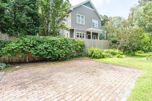 a view of a house with a yard and sitting area