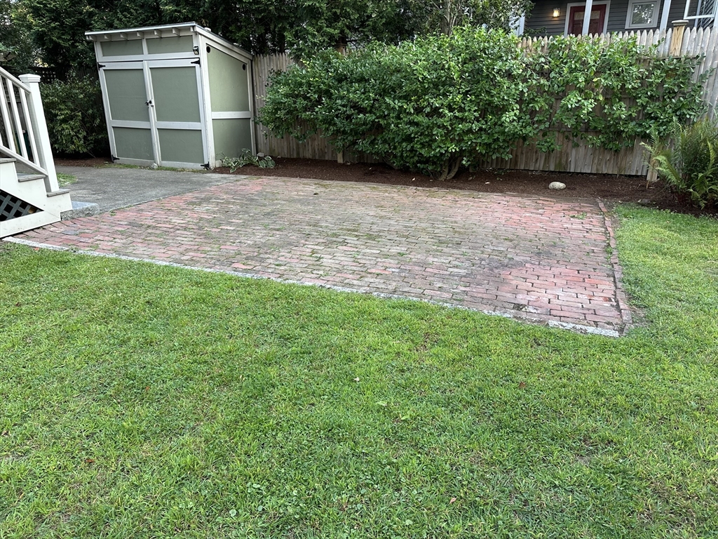 40 Cushing Street, Unit 40 Cambridge, MA 02138 - Photo 42 of 42 a backyard of a house with lots of green space and wooden fence