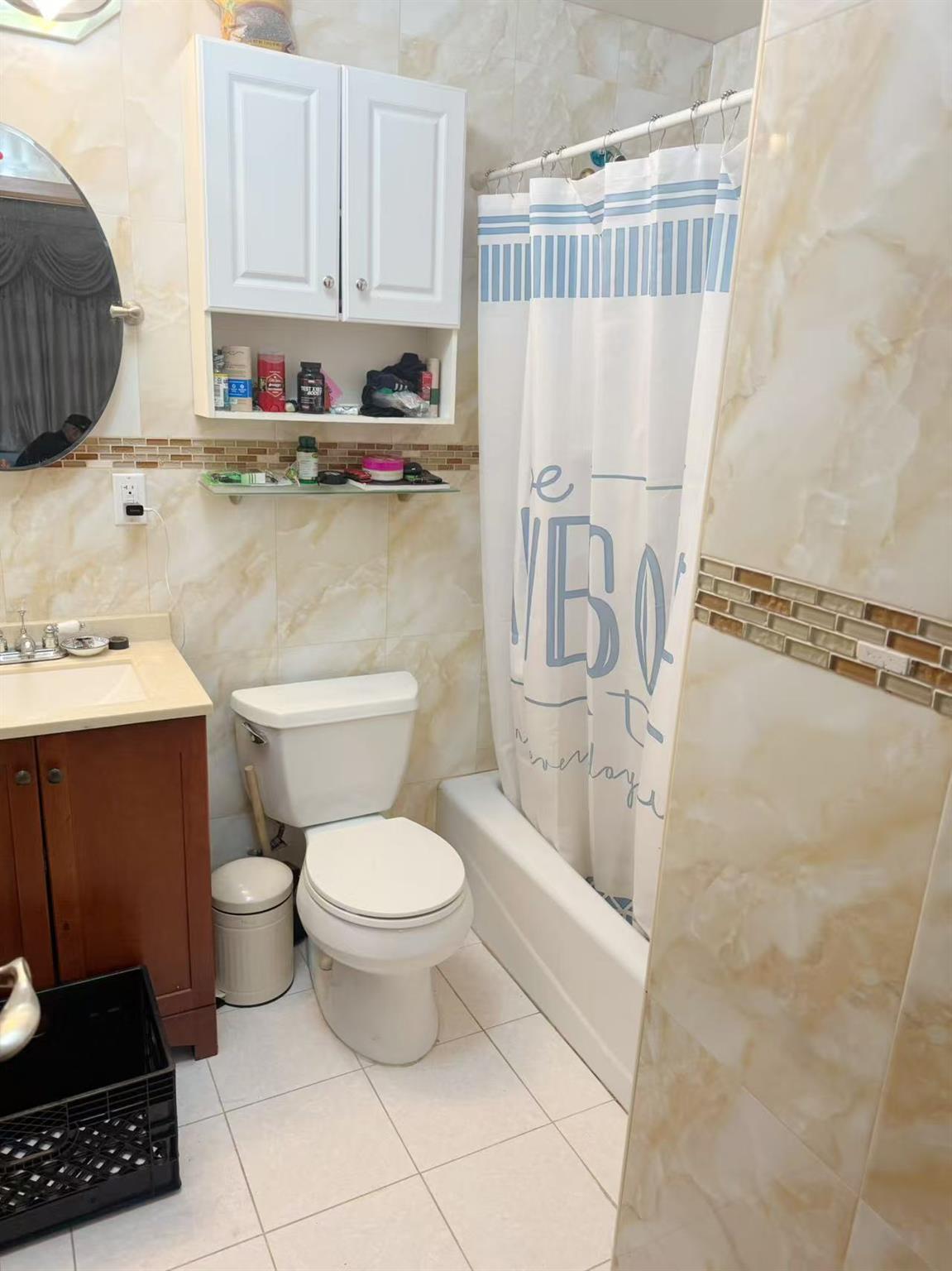 108-31 50th Avenue, Unit 3A Queens, NY 11368 - Photo 5 of 7 Bathroom featuring tile walls, vanity, tile patterned floors, and shower / bath combination with curtain