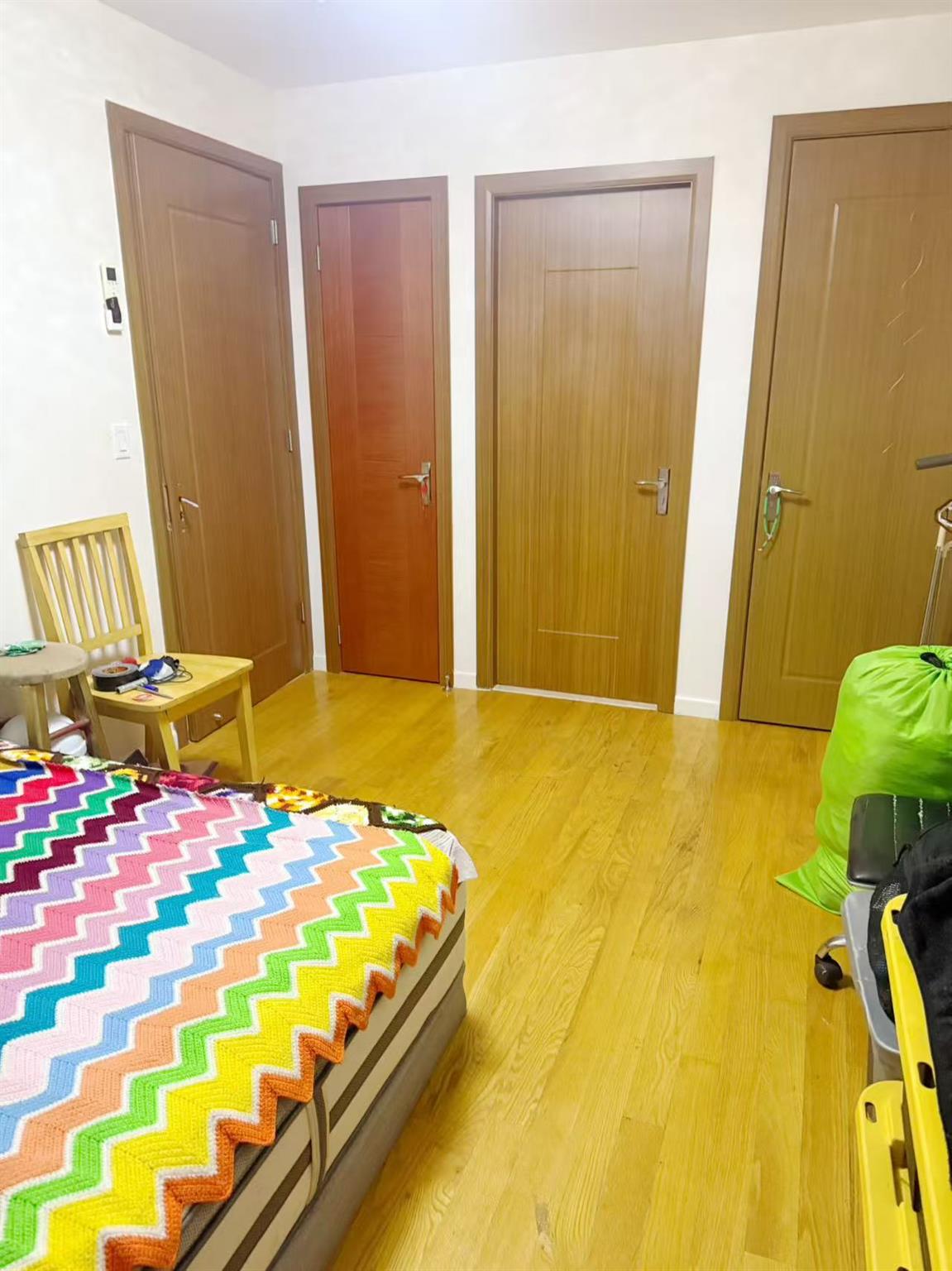 108-31 50th Avenue, Unit 3A Queens, NY 11368 - Photo 6 of 7 Bedroom featuring light wood-style flooring and multiple closets