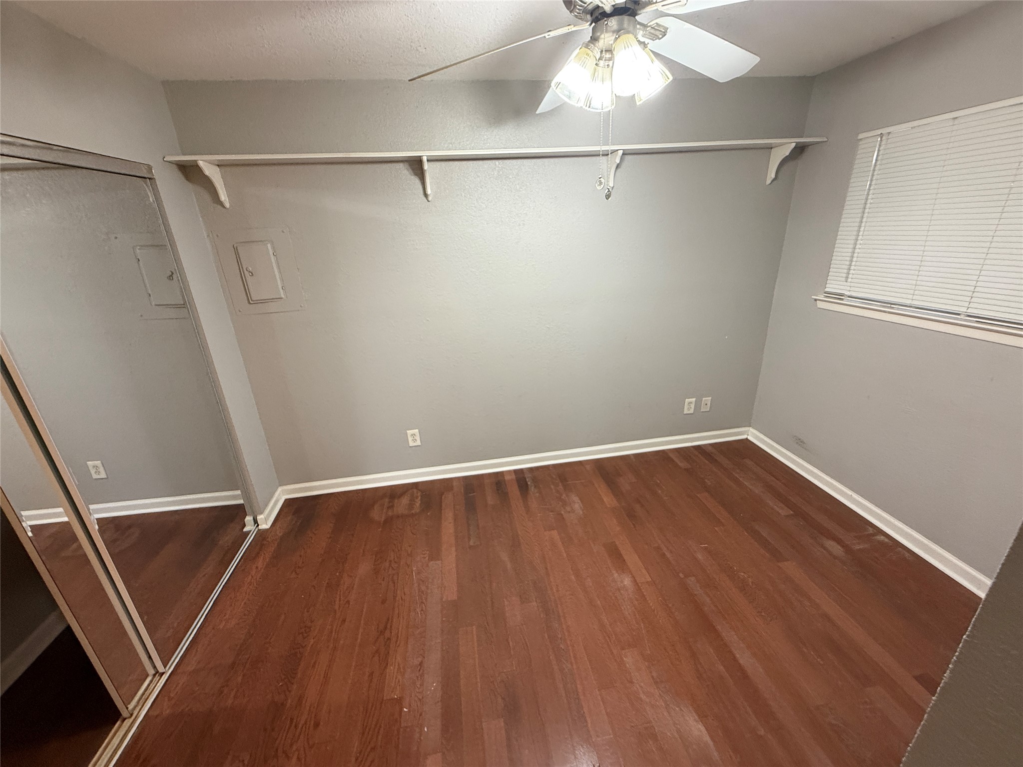 2500 Burleson Road, Unit 209 Austin, TX 78741 - Photo 8 of 15 Gleaming hardwood floors and built-in shelving define this versatile room.
