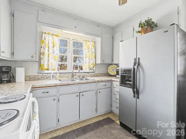 a kitchen with appliances cabinets and a sink