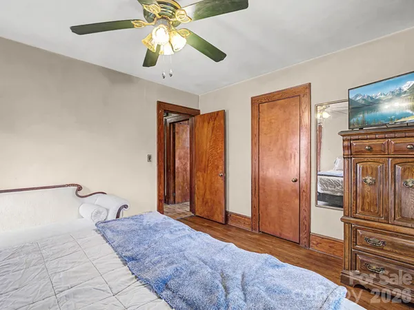 a spacious bedroom with a bed and a chandelier