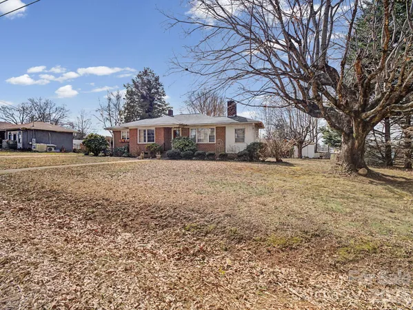 a view of large house with a yard