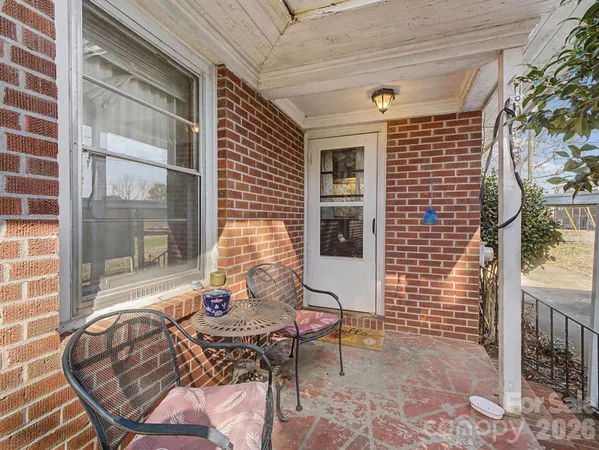 a balcony with chairs and with outdoor views