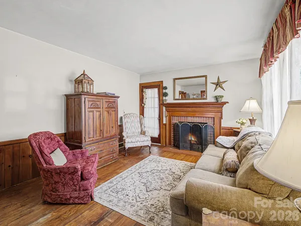 a living room with furniture a rug and a fireplace