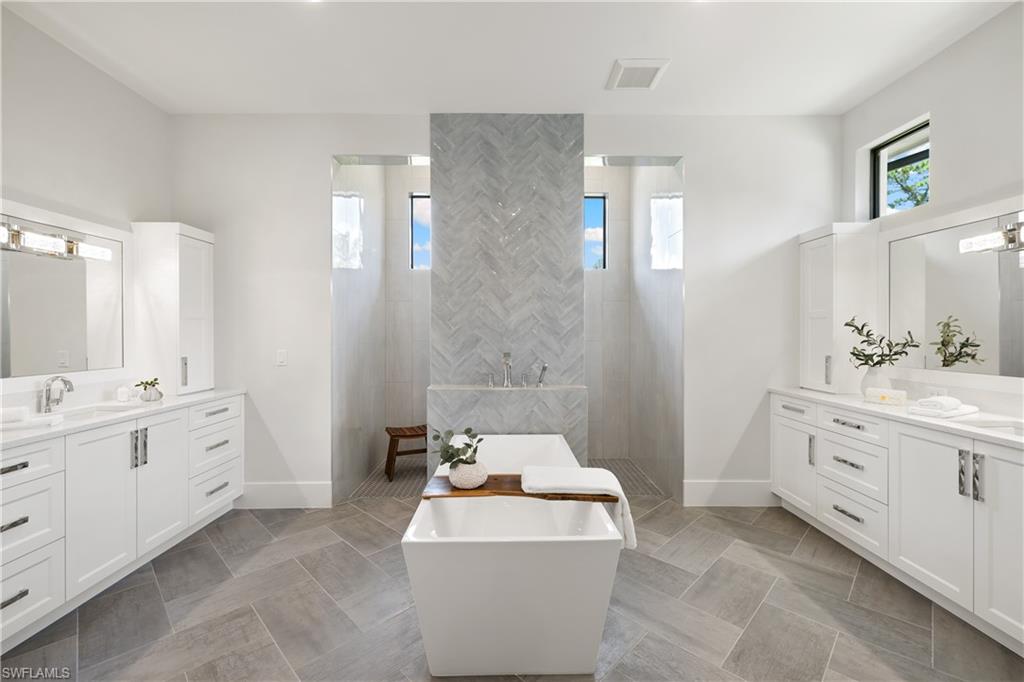 4751 1st Avenue Southwest Naples, FL 34119 - Photo 14 of 25 a spacious bathroom with double vanity sink a bathtub and a shower
