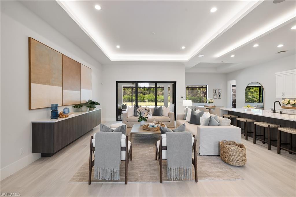 4751 1st Avenue Southwest Naples, FL 34119 - Photo 5 of 25 a living room with furniture kitchen view and a large window