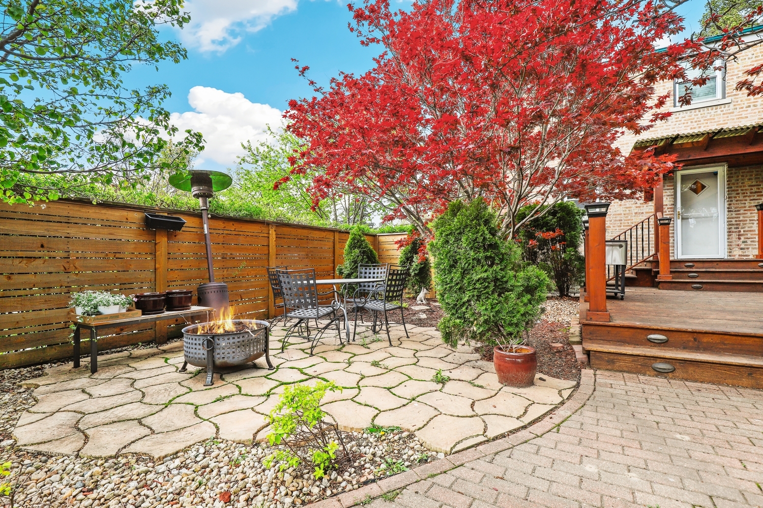 2357 South 3rd Avenue North Riverside, IL 60546 - Photo 22 of 28 a view of a patio with table and chairs potted plants and a large tree