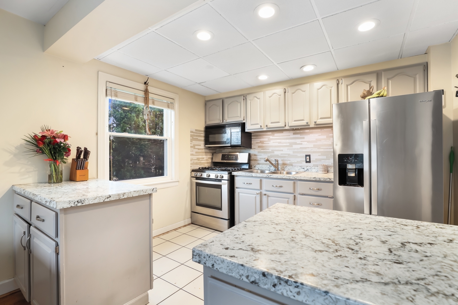 2357 South 3rd Avenue North Riverside, IL 60546 - Photo 7 of 28 a kitchen with stainless steel appliances granite countertop a refrigerator sink stove microwave and cabinets