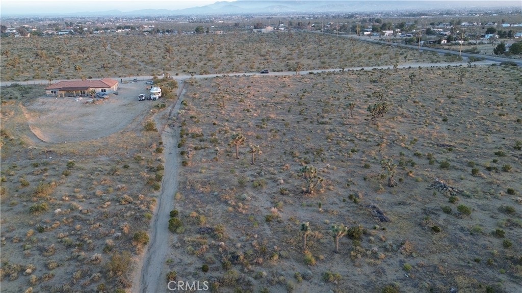 3098 La Mesa Road Phelan, CA 92371 - Photo 1 of 8 a view of a dry yard with mountains in the background