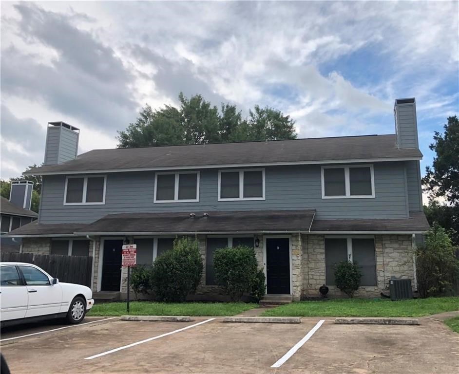 a view of a car parked in front of brick building