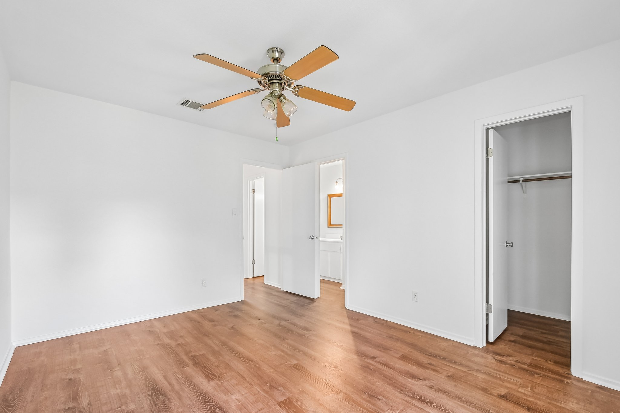 4202 Hudson Bend Road, Unit B Austin, TX 78734 - Photo 12 of 26 a view of a room with wooden floor and a ceiling fan