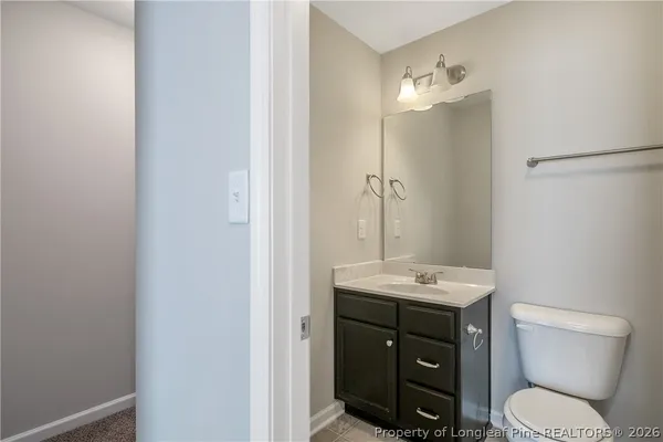 a bathroom with a toilet a sink and mirror