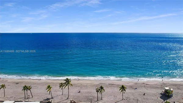 a view of an ocean beach and mountain