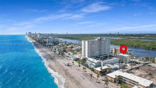 a view of swimming pool with outdoor seating space and lake view