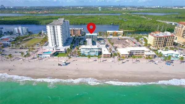 an aerial view of a house with a lake view