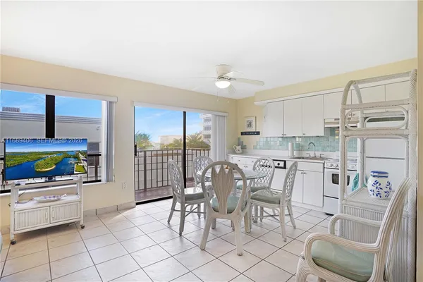 a dining room with furniture a floor to ceiling window and outdoor view