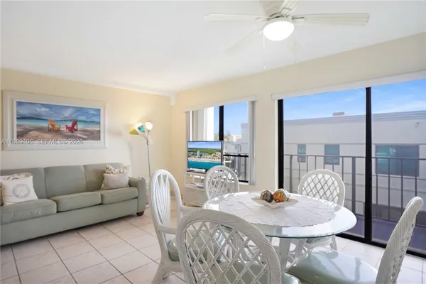 a living room with furniture a dining table and a chandelier